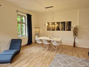 a living room with a dining room table and chairs at Villa Caggiati in Bad Schandau