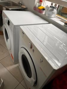 a white washer and dryer in a kitchen at Not Very Quiet But Best location in London