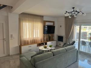 a living room with a couch and a table at Milena's Luxury Villa in Iraklitsa