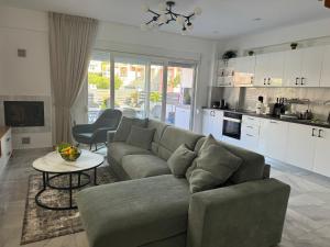 a living room with a couch and a table at Milena's Luxury Villa in Iraklitsa