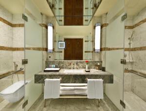 a bathroom with a sink and a toilet at Conrad Makkah in Makkah