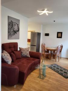 a living room with a couch and a table at Appartement Purzel in Mauerbach