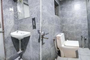 a bathroom with a toilet and a sink at FabHotel Leo Pride in Aurangabad