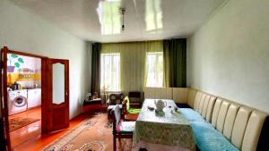 a room with a bed and a table in it at Eagle's Nest in Karakol