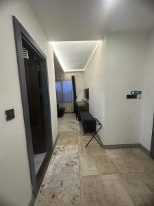 a room with a hallway with a door and a chair at Amorium Hotel in Kastamonu