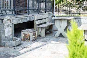 a bench and a table and a bench and a table at ANGO First Floor Apartment in Stavros