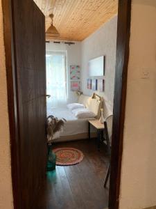 a small bedroom with a bed and a window at Melnicani, Breathtaking view in Debar