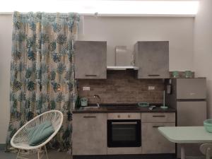 a small kitchen with a sink and a stove at Alice's Studio in Santa Marinella