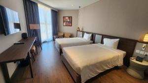 Ένα ή περισσότερα κρεβάτια σε δωμάτιο στο Apec Mandala Condotel Mũi Né +6 φωτογραφίες