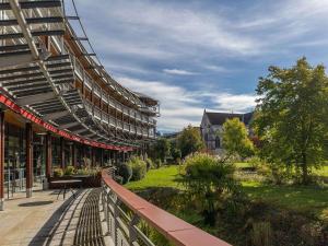 un edificio con una pasarela junto a un parque en Hotel Parc Beaumont & Spa Pau - MGallery en Pau