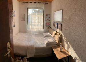 a small bedroom with a bed and a window at Melnicani, Breathtaking view in Debar
