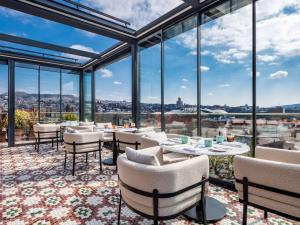 a dining room with a view of the city at Swissôtel Tbilisi in Tbilisi City