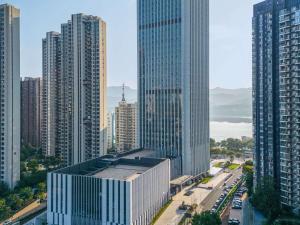 an aerial view of a city with tall buildings at Grand Mercure Yichang Waitan in Yichang