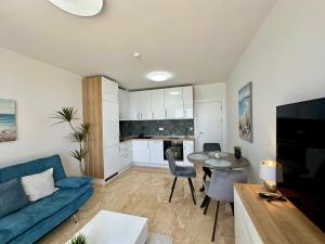 a living room with a blue couch and a table at ONYX 1 - Menada Apartments in Sveti Vlas