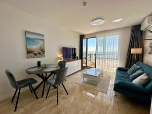 a living room with a blue couch and a table at ONYX 1 - Menada Apartments in Sveti Vlas