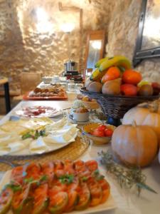a buffet of food with fruits and vegetables on a table at Mas Coquells Rural - Habitació doble amb bany i terrassa privada in Vilanant