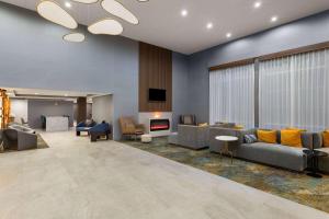 a large living room with couches and a fireplace at Hawthorn Extended Stay by Wyndham Knoxville in Knoxville