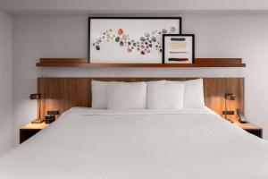 a bed in a hotel room with a white bed at Hawthorn Extended Stay by Wyndham Knoxville in Knoxville +20 photos