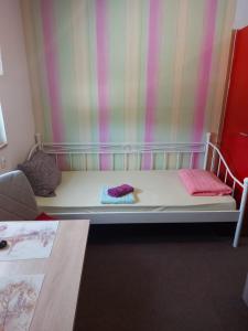 a bed with two pillows on it in a room at Neiras Apartments Blagaj in Blagaj +24 photos