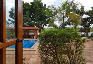 uma vista para uma piscina a partir de uma janela em Changthai Comfort Guest House em Ban Nong Phai