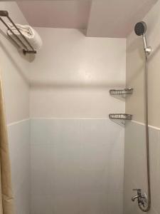 a bathroom with a shower with a shower head at KaribuBnb in Lapu Lapu City