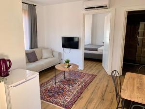 a living room with a couch and a table at Sabah Homes in Antalya