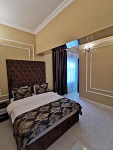 a bedroom with a large bed and a window at Raffles Villa with pool in Gabala