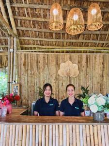 two women sitting at a bar in a restaurant at Rose Villas & Resort - Ba Vi- A120 in Ba Vì