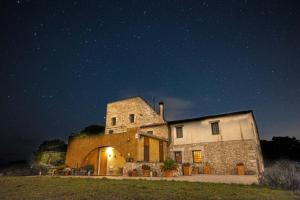 an old stone building at night with a starry sky at B&B Mas Coquells Habitación Genover in Vilanant +5 photos