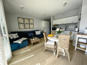 a living room with a blue couch and a table at Edel Exclusive Apartments Balticus A 48 Especially for You in Międzyzdroje