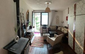a living room with a couch and a table at Melnicani, Breathtaking view in Debar