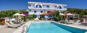 a hotel with a swimming pool and a building at Havania Apartments in Agios Nikolaos