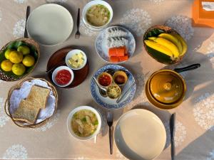 a table topped with plates and bowls of food at The Thai House Homestay & Thai Cooking Experiences in Ban Bang Sano