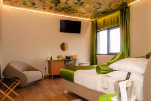 a hotel room with a bed and a chair at Hotel Vinotel Gospoja in Vrbnik
