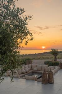a living room with a couch and a sunset at Brioni - Plant Villas, with luxury service in Novalja +56 photos
