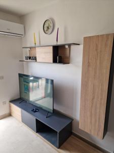 a fish tank on a stand in a room at Sky Apartment 3 in St Paul's Bay