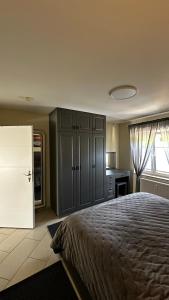 ein Schlafzimmer mit einem Bett und einem Kühlschrank sowie eine Küche in der Unterkunft Sonnenseite in Laboe
