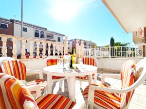 a white table and chairs on a balcony at Sunny Blue Home - near Pools, Beach and Golf in Los Alcázares