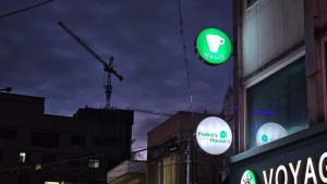 a couple of green and white signs on a building at Pedro's House - Foreigners only in Gwangju