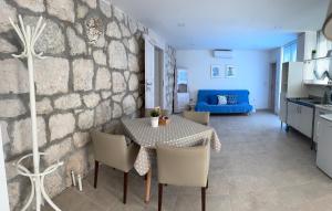 a kitchen and living room with a table and chairs at Villa Viden Apartments in Tučepi