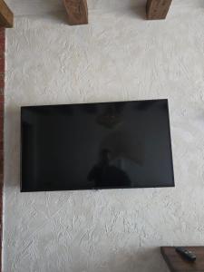 a flat screen tv hanging on a white wall at MAVİ AT HOTEL Blue Horse in Gümüşdere