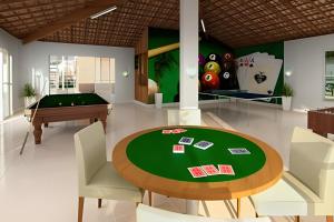 a dining room with a table and a pool table at Casa condomínio fechado. in Petrolina