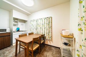 a kitchen and dining room with a table and chairs at 84-5, Shiomi 301, Entire room for rent in Tokyo