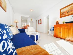 a living room with a blue couch and a table at Sunny Blue Home - near Pools, Beach and Golf in Los Alcázares +27 photos