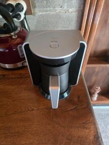 a coffee maker sitting on top of a counter at MAVİ AT HOTEL Blue Horse in Gümüşdere