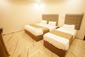 Postel nebo postele na pokoji v ubytování HOTEL VILVAAS
