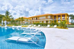 a row of lounge chairs in front of a resort at Hotel Mocawa Resort in La Tebaida