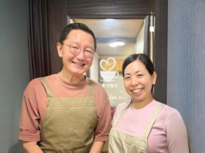a man and a woman standing next to each other at Guest House Pongyi in Kanazawa