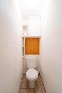 un piccolo bagno con servizi igienici bianchi e armadio di Rez de Chausse T1 Bozel a Bozel