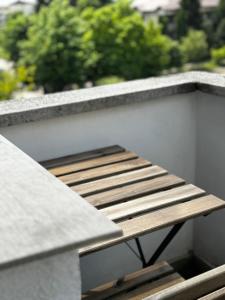 a wooden bench sitting on the side of a building at Lux Apartment Vivo Mall in Baia Mare